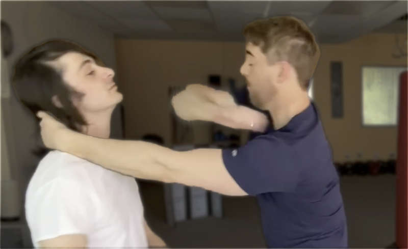 Elbow strike to face from Thai clench